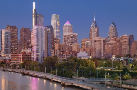 Photo for Philadelphia Downtown skyline at Night with the Schuylkill river. Beautiful Sunset Light. Schuylkill River Trail in Background. City skyline glows under the beautiful sunset light. PA, USA. - Royalty Free Image