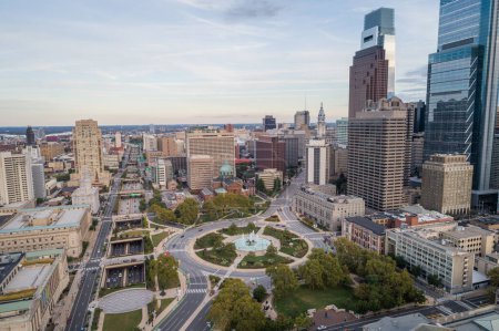Photo for Logan Square and Philadelphia Skyline, Downtown. Pennsylvania, USA. Traffic circle center features a large fountain with whimsical statuary, garden areas with benches. - Royalty Free Image