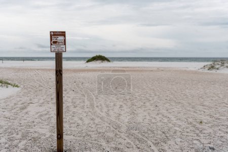 Photo for Pack it In, Pack It Out Sign in Pensacola beach, Florida. - Royalty Free Image