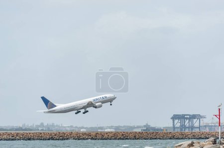 Photo for SYDNEY, AUSTRALIA - NOVEMBER 11, 2014: Sydnay International Airport With Take Off Airplane. Aircraft N220UA, Boeing 777-222, United Airlines - Royalty Free Image