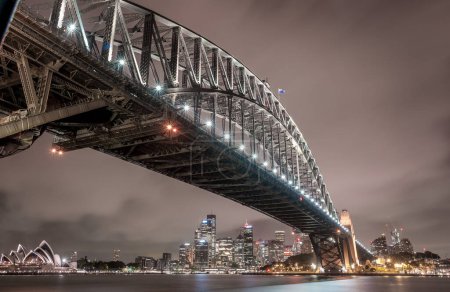 Photo for Sydney Harbour Bridge and Opera House at Night. Beautiful Sydney Cityscape and Skyline. Long Exposure. Flowing Sky. Australia - Royalty Free Image
