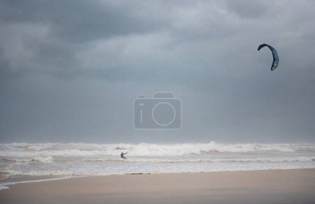 Téléchargez les photos : Stormy Mediterranean Sea and Cloudy Sky in Tel Aviv, Israel. Man with Power Kite - en image libre de droit