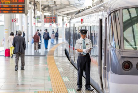 Téléchargez les photos : TOKYO, JAPAN - OCTOBER 30, 2019: Seibu Shinjuku Railway station in Shinjuku, Tokyo, Japan, Train Driver is waiting to depart. Portrait. - en image libre de droit