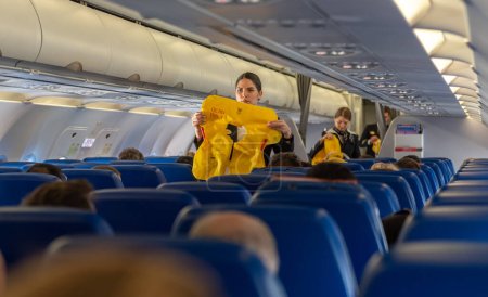 Téléchargez les photos : ROME, ITALY - OCTOBER 23, 2019: Aeroflot Russian Airlines Cabin Crew Safety Demonstration in airplane before departure. - en image libre de droit