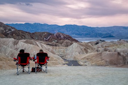 Photo for Zabriskie Point. It is a part of the Amargosa Range located east of Death Valley in Death Valley National Park in California, United States. People Are Watching Sunset. USA - Royalty Free Image