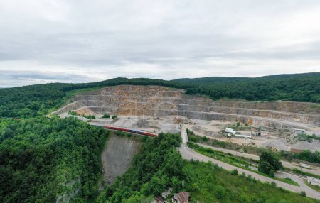 Foto de Stone Quarry in Croatia, Europe. Aerial View of Opencast Mining Quarry With Lots of Machinery. View from Above. Marble Mining Industry. - Imagen libre de derechos