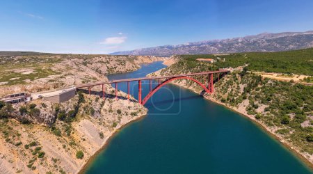 Photo for Maslenica Bridge Most in Croatia. The Maslenica Bridge is a deck arch bridge carrying the state road spanning the Novsko Zdrilo strait of the Adriatic Sea. Beautiful Landscape in Background. - Royalty Free Image