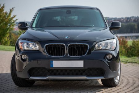 Téléchargez les photos : BMW X1 2012 Year R18 Wheels is a compact sport utility vehicle. Black Color. Beautiful Sunny Background. - en image libre de droit