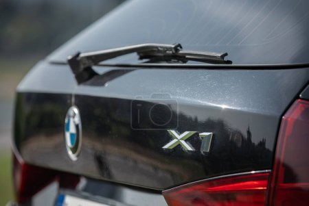 Téléchargez les photos : BMW X1 2012 Year compact sport utility vehicle. Black Color. Closeup X1 Sign - en image libre de droit