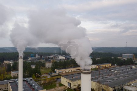 Photo for Smoking chimneys on the late autumn sky background. Heating season. The view of chimneys tops of the thermal station. - Royalty Free Image