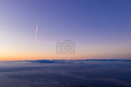 Téléchargez les photos : Zagreb Skyline in Croatia. Sunset Light Colorful Sky and Castle in Background. View from the top of Medvednica Mountain. Haze Background. - en image libre de droit