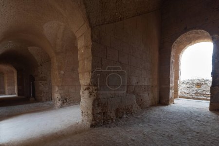 Photo for Interior of Amphitheatre of El Jem in Tunisia. Amphitheatre is in the modern-day city of El Djem, Tunisia, formerly Thysdrus in the Roman province of Africa. It is listed by UNESCO since 1979 as a World Heritage Site - Royalty Free Image