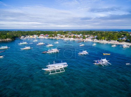 Photo for Sunny Day in Malapascua Island in Visayan Sea, One of Cebu Island in Philippines. Blue Sea water and Boats. Bounty Beach - Royalty Free Image