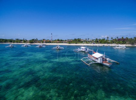 Photo for Sunny Day in Malapascua Island in Visayan Sea, One of Cebu Island in Philippines. Blue Sea water and Boats in Background - Royalty Free Image