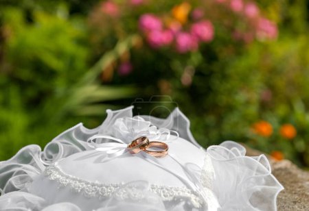 Photo for Wedding Ring on White Pillow. Blurry Background. - Royalty Free Image