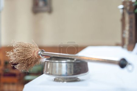 Photo for Aspergillum in the church. Liturgical implement used to sprinkle holy water - Royalty Free Image