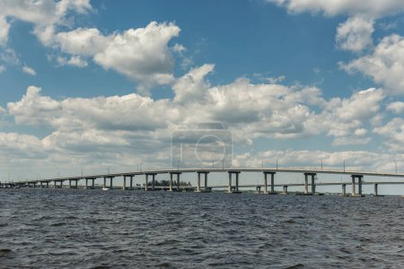 Téléchargez les photos : Fort Myers Landscape and Cityscape with Water and Cloudy Blue Sky. Caloosahatchee river and Bridges. Florida. USA - en image libre de droit