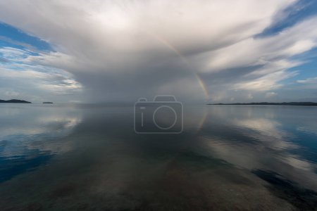 Clouds and Ocean Water with Rainbow. Reflection. Palau Islands. Micronesia.