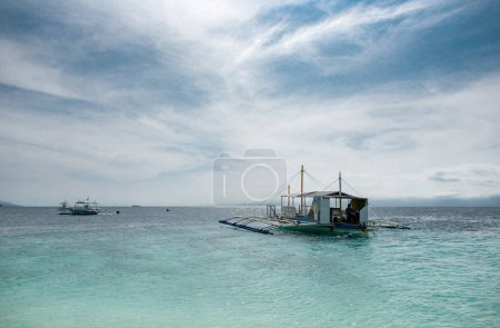 Photo for MALAPASCUA, PHILIPPINES - FEBRUARY 07, 2018: Empty Beach in Malapascua, Philippines. Clear blue sky and ocean water. - Royalty Free Image