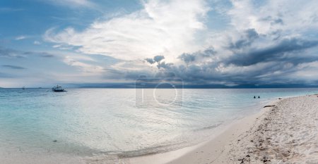 Photo for Stormy Sky and Ocean Water in Philippines. Sandy beach in foreground. - Royalty Free Image