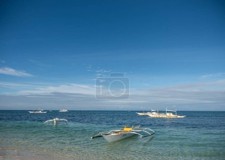 Photo for MALAPASCUA, PHILIPPINES - FEBRUARY 07, 2018: Empty Beach in Malapascua, Philippines. Clear blue sky and ocean water. - Royalty Free Image