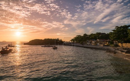 Photo for Sunset time in Malapascua island. Sunset colorful sky. Landscape photo with beach and boats in ocean water. - Royalty Free Image
