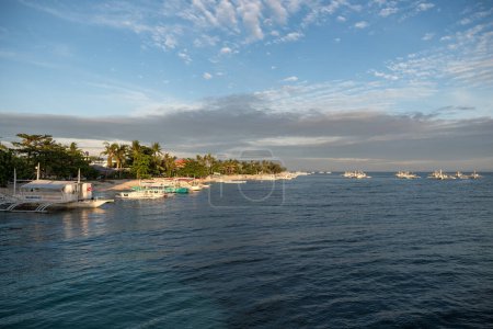 Photo for MALAPASCUA, PHILIPPINES - FEBRUARY 07, 2018: Empty Beach in Malapascua, Philippines. Clear blue sky and ocean water, sandy beach and boats. - Royalty Free Image