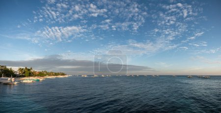 Photo for MALAPASCUA, PHILIPPINES - FEBRUARY 07, 2018: Empty Beach in Malapascua, Philippines. Clear blue sky and ocean water, sandy beach and boats. - Royalty Free Image