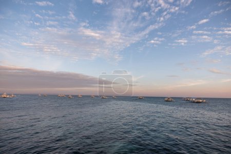 Photo for Ocean Water and Empty Boats in Background. Philippines. Malapascua Island View in Sunset time. - Royalty Free Image