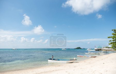 Photo for MALAPASCUA, PHILIPPINES - FEBRUARY 09, 2018: Beach in Malapascua. Bright White Sand with Empty Boats in Background. Philippines. - Royalty Free Image