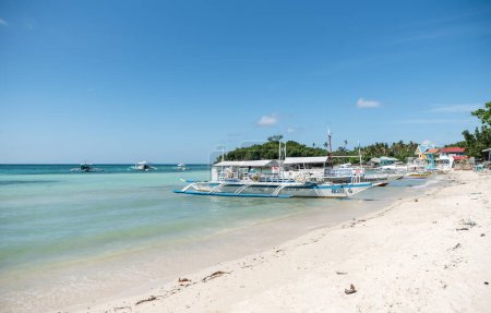 Photo for MALAPASCUA, PHILIPPINES - FEBRUARY 09, 2018: Beach in Malapascua. Bright White Sand with Empty Boats in Background. Philippines. - Royalty Free Image