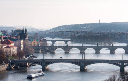 PRAGUE, CZECH - MARCH 14, 2016: CItyscape of Prague, Charles Bridge, Karlov, Manesuv Most Bridge, Old Town Area. Tourist Barge in Vltava