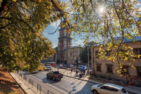 Photo for LVIV, UKRAINE - SEPTEMBER 09, 2016: Lviv Citycape and People. Lviv Old Town. Public Transport. Dormition Church, Korniakt Tower - Royalty Free Image