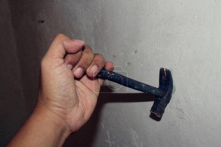 pulling nails out of the wall