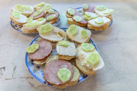 Breakfast sandwiches with sausage, cheese and cucumber.