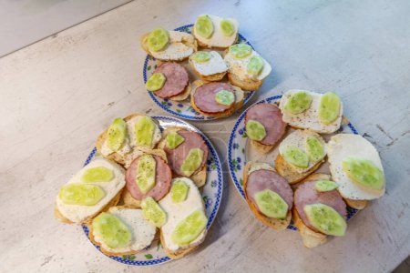 Breakfast sandwiches with sausage, cheese and cucumber.
