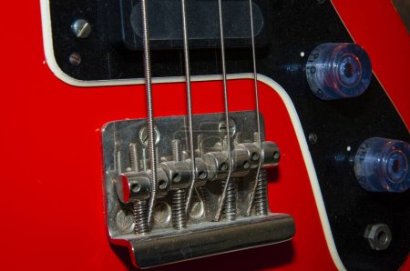 Photo for Electric bass guitar red color with string on fingerboard for rock music. - Royalty Free Image