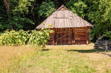 Authentic Ukrainian house in countryside. Summer village in Ukraine. Old folk thatched house. Ukrainian vintage traditional rustic house. Rural countryside in summer ranch. Architecture.