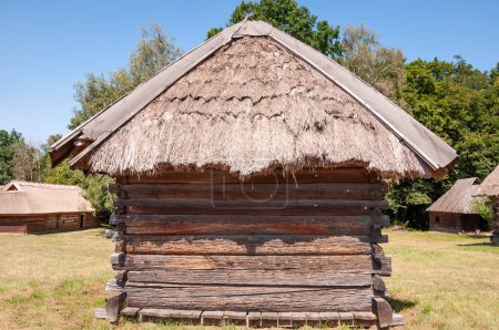 Authentic Ukrainian house in countryside. Summer village in Ukraine. Old folk thatched house. Ukrainian traditional rustic house or stable. Rural countryside in summer ranch. Architecture.