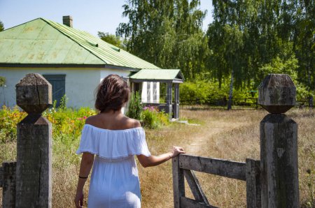 Photo for Countryside woman in summer go to village cottage house outdoor. - Royalty Free Image