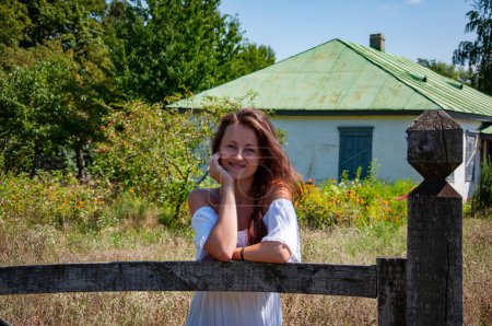 Photo for Countryside young woman in summer at village cottage house outdoor. - Royalty Free Image