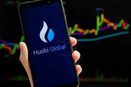 Photo for Ukraine, Odessa - October, 9 2021: Huobi Global mobile app running at smartphone screen with trading candlestick chart at background. Huobi Global is cryptocurrency exchange and trading platform - Royalty Free Image