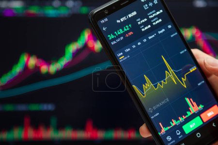 Photo for Ukraine, Odessa - June, 1 2021: Trading pair BTC BUSD at Binance mobile app running at smartphone screen with trading page in background. It's one of world's leading cryptocurrency trading platform. - Royalty Free Image