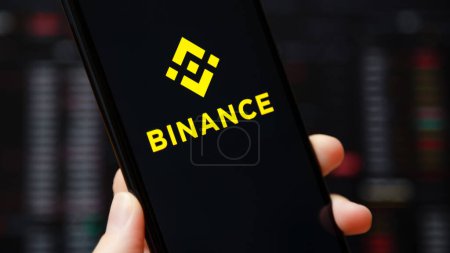 Photo for Ukraine, Odessa - June, 1 2021: Binance mobile app running at smartphone screen with a trading page at background. Binance one of the world's leading cryptocurrency exchange and trading platform. - Royalty Free Image