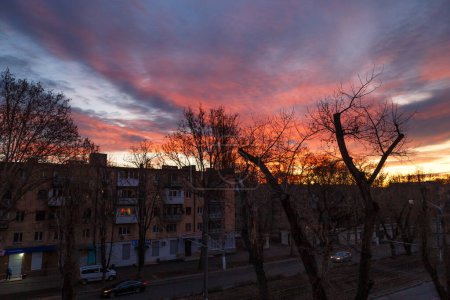 Photo for Morning city street in the post-Soviet country, top view. A stunning pink, orange and violet clouds at sunrise sky, sunset city background - Royalty Free Image