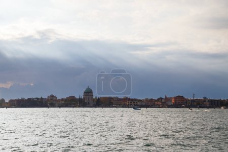 Lido island viewed from Venetian lagoon. The Votive Temple church or Tempio Votivo della Pace di Venezia on Lido island of Venice, Italy.