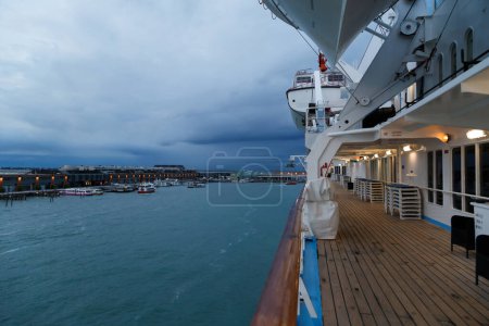 View of the Cruise Port of Venice from the open deck of the passenger cruise ship, evening, cloudy weather. Travel concept.