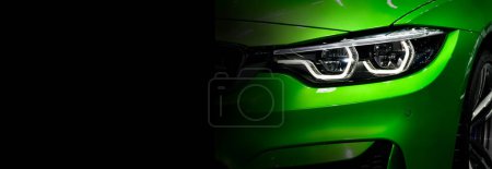 Photo for Green modern car headlights on black background ,copy space - Royalty Free Image