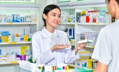  Female pharmacist holding medicine giving advice to customer in pharmacy store