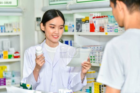 Female pharmacist holding medicine giving advice to customer in pharmacy store